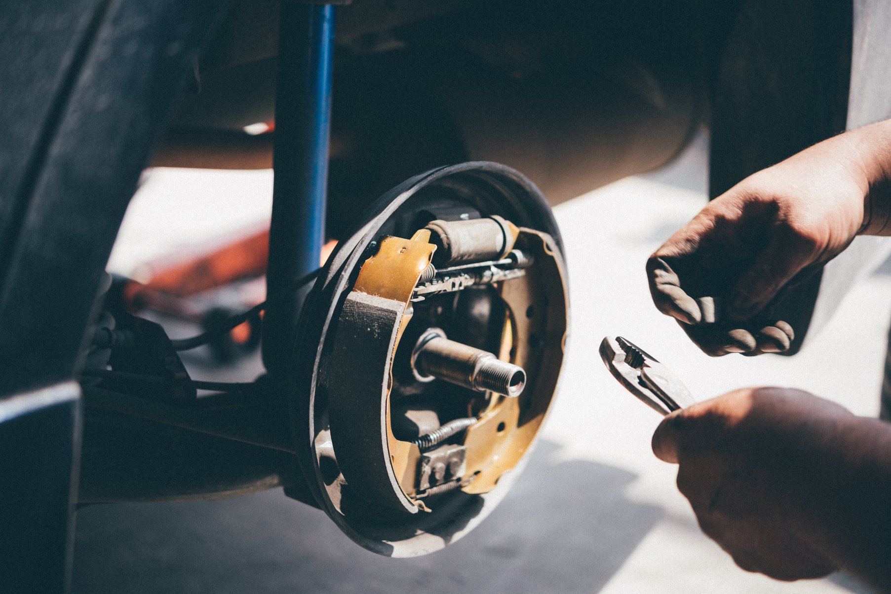 Drum brake and asbestos brake pads at car garage